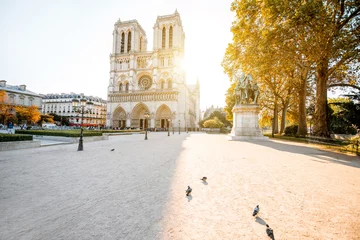 Tuinposter View on the famous Notre-Dame cathedral and empty square during the morning light in Paris, France © rh2010