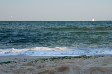 Sailing yacht with white sails in the open Sea.