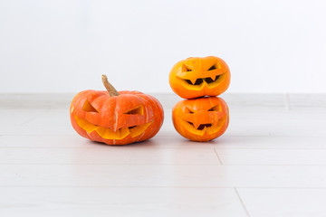 Halloween pumpkins. Funny Jack O'Lantern on the light room