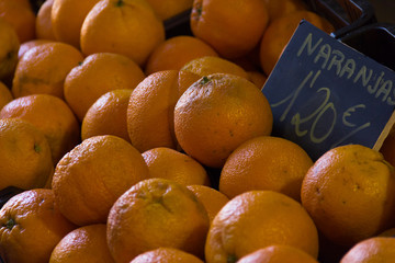 Oranges box with price tag. Food market stand. Groceries, organic fruit, supermarket, agriculture, crop, healthy eating concepts. Language translation: oranges