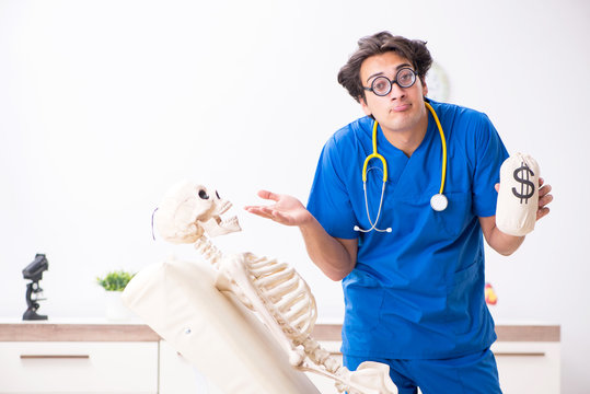 Funny doctor with skeleton in hospital