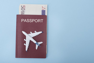 Fototapeta premium Airplane on the cover of the passport. Euro. Travel concept. Blue background