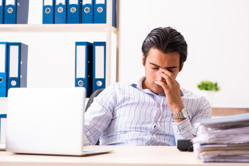 Young employee sitting at the office 
