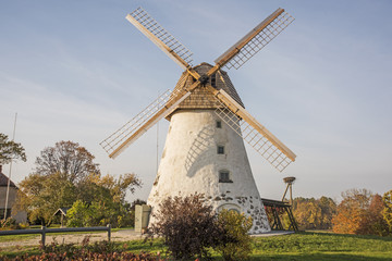 Obraz premium Restored old windmill on the mountainside. Autumn sunny day.