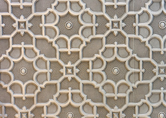 Wall panel in brown tones with a three-dimensional ornament. The element of decor.