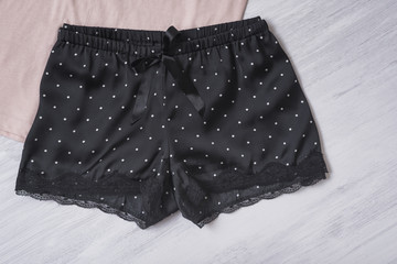 Black satin shorts with lace. Fashion concept