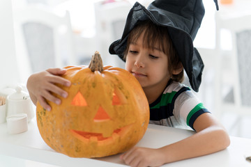 Fototapeta premium Cute kid with Halloween pumpkin