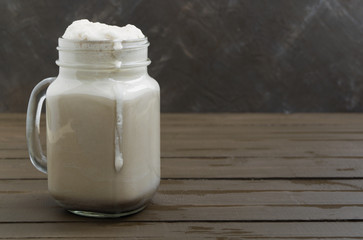 Cocoa in a jar on a wooden table.