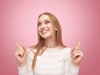Pretty blond woman pointing up
