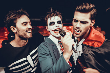 Young Men in Halloween Costumes Singing Karaoke