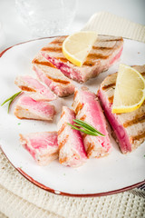 Grilled tuna fish steaks with lemon and spices