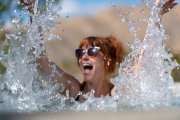Close up of girl splashing water on hot tub