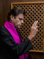 Portrait of a priest in his confessional