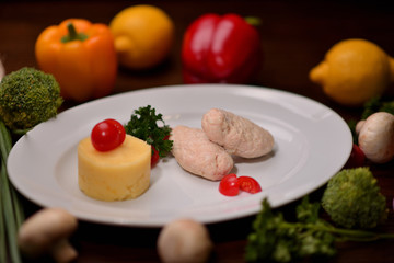 meatballs with mashed potatoes and vegetables on a white plate