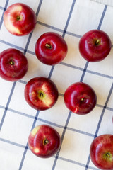 Raw red apples on cloth, overhead view. Flat lay, from above, top view.