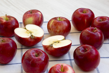 Fresh raw red apples on white wooden background, side view. Closeup.
