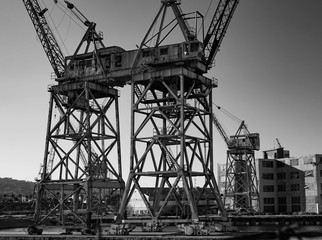 Abandoned shipyard with gantry cranes and empty buildings once loaded and unloaded cargo from ships...