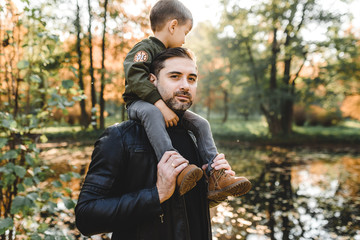 Naklejka na ściany i meble father and son in autumn park