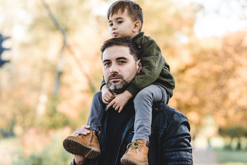 father and son in autumn park