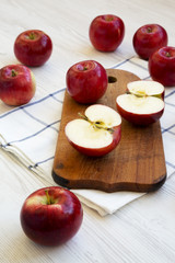 Fresh raw red apples on white wooden table, side view. Close-up.