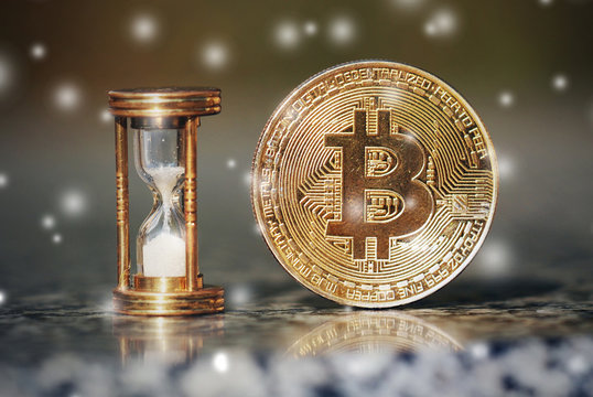 The physical bitcoin and hourglass show the time is coming, winter is came