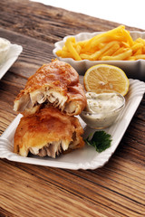 traditional British fish and chips consisting of fried fish, potato chips and mayonnaise