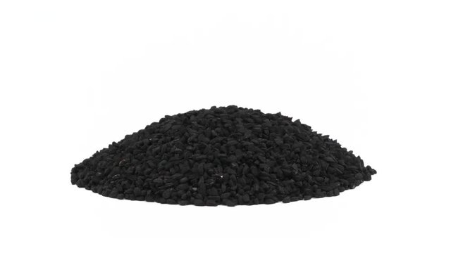 Heap of black cumin. Rotating on the turntable. Isolated on the white background. Close up. Macro.
