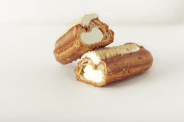 eclair with cream on white background. isolated
