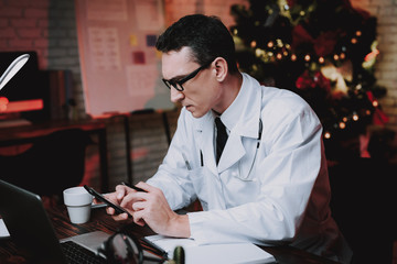 Tired Doctor in Uniform in Office on New Year Eve.