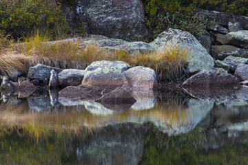 Magical and suggestive piece of mountain reflected on water
