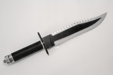 large hunting knife with rope handle and serrated face.