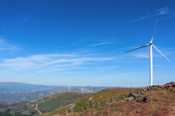 Gorgeous view of rocky mountain landscape with wind turbines in the distance. Beautiful clear blue sky. Aveiro, Portugal