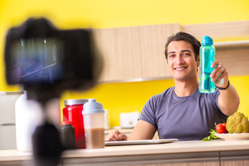 Young man blogging about food supplements