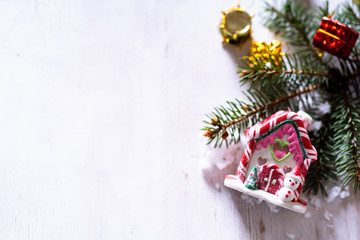 Christmas house and decorations on wooden background