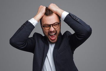 Screaming businessman pulling out hair