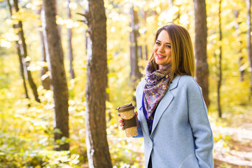 Autumn, drinks and people concept - Woman holding cup of hot drink