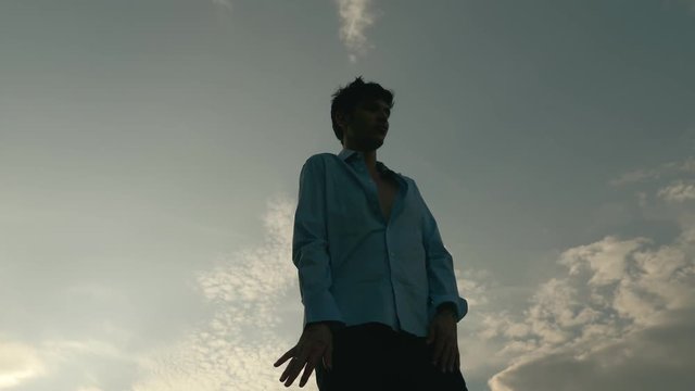 Man's silhouette dancing at sunset.carefree,joy,fun