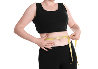 Overweight woman measuring waist before weight loss on white background