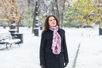 Winter, fashion and people concept - Portrait of young woman is taking a walk outdoors