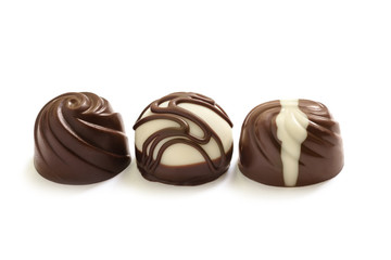 Fototapeta premium Assortment of chocolate candies from black, milk and white chocolate with nuts and marzipan