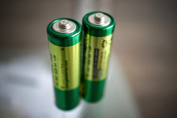 Perspective view of two green AA alkaline batteries