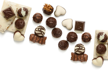 Assortment of chocolate candies from black, milk and white chocolate with nuts and marzipan