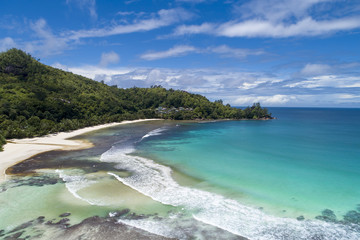 Tropical beach with sea and palm taken from drone. Beach and sea photo. Romantic beach aerial view.