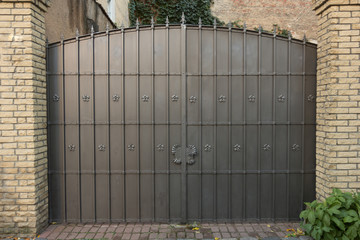 decorative metal gate surrounded with brick construction