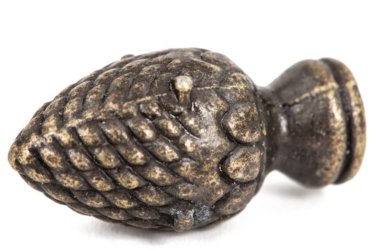 Decorative element in the form of pine cone from bronze, isolated on white background