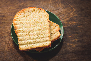 toast of sliced bread on a wooden background.