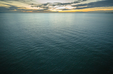 Horizon and ocean blending together at sunset time on a cloudy day