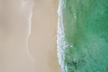 Beautiful tropical white empty beach and sea waves seen from above. Seychelles beach aerial view