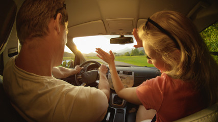 CLOSE UP: Energetic couple having fun during their road trip through countryside