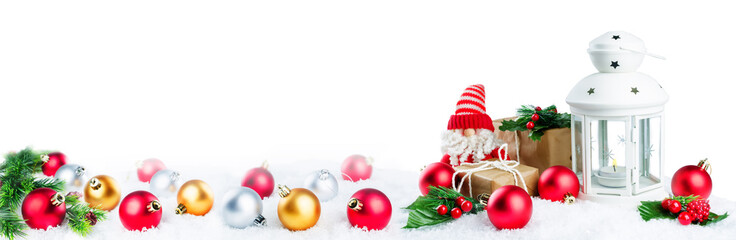 Christmas lantern with gifts, colored balls and Santa Claus on snow isolated background